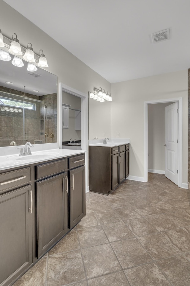 bathroom featuring vanity and a shower with door