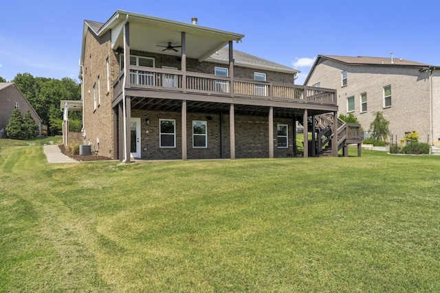 rear view of house featuring central AC unit, ceiling fan, a lawn, and a wooden deck