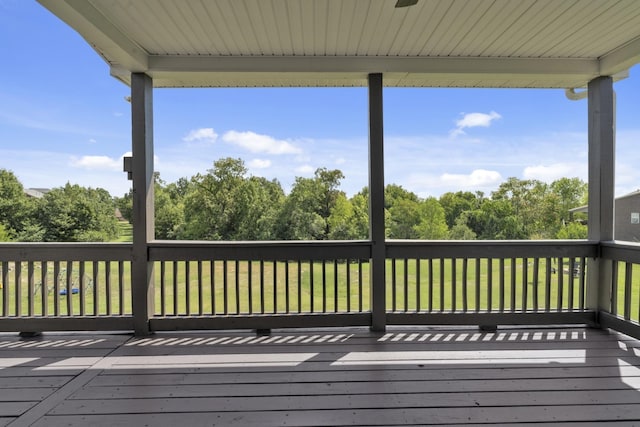 wooden deck featuring a yard