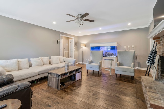 living room featuring a brick fireplace, ceiling fan, ornamental molding, and hardwood / wood-style flooring