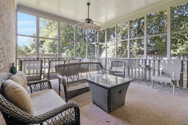 sunroom / solarium featuring ceiling fan and a healthy amount of sunlight