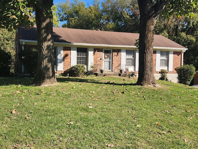 ranch-style home with a front lawn