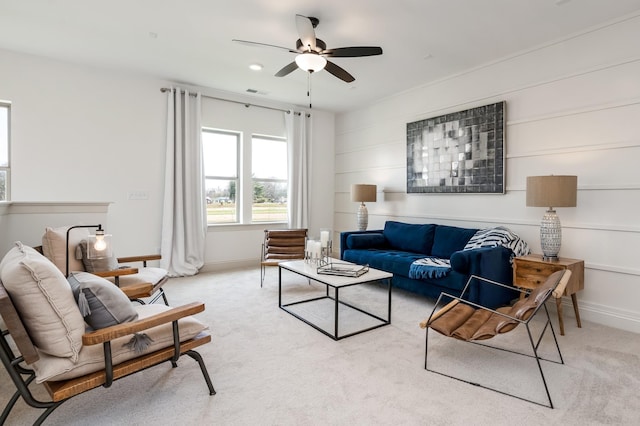 living room with ceiling fan and light colored carpet