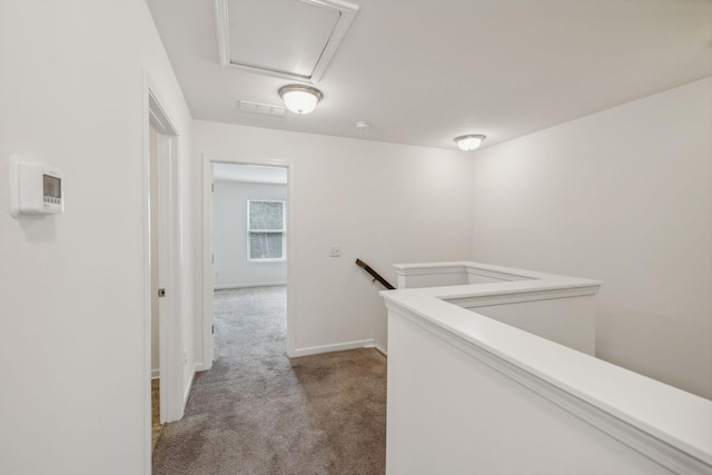 hallway featuring light colored carpet