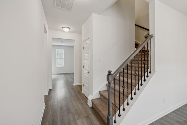 stairs featuring wood-type flooring