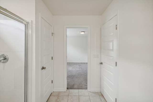 hall featuring light colored carpet