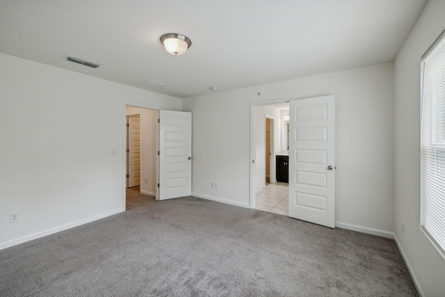 unfurnished bedroom with light carpet