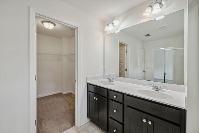 bathroom featuring vanity, tile patterned floors, and a shower with door