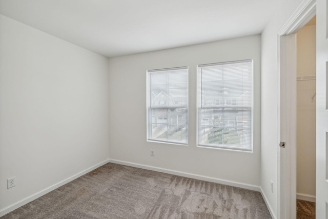 unfurnished room with light carpet