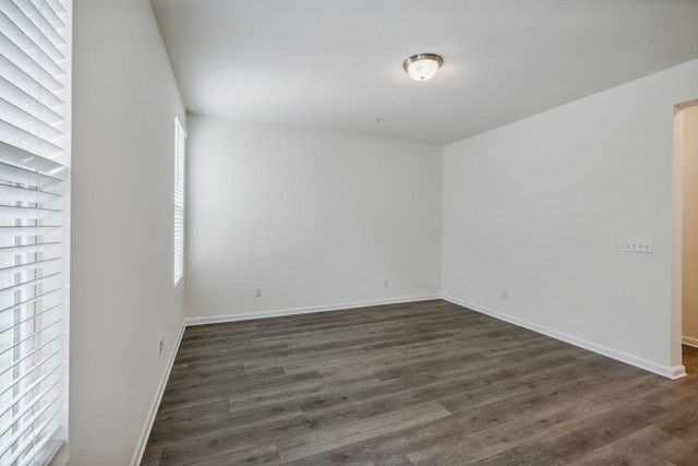 empty room featuring dark hardwood / wood-style flooring