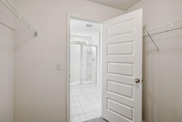 walk in closet featuring light tile patterned flooring