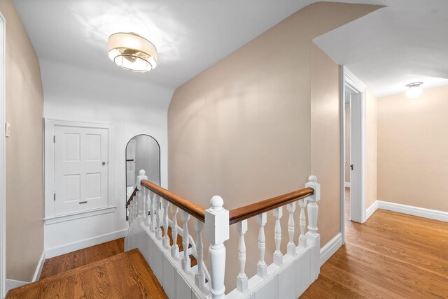 hallway with hardwood / wood-style flooring