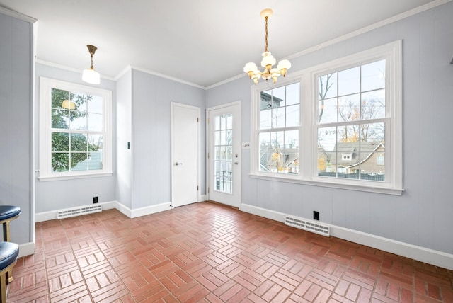 unfurnished dining area with ornamental molding and an inviting chandelier