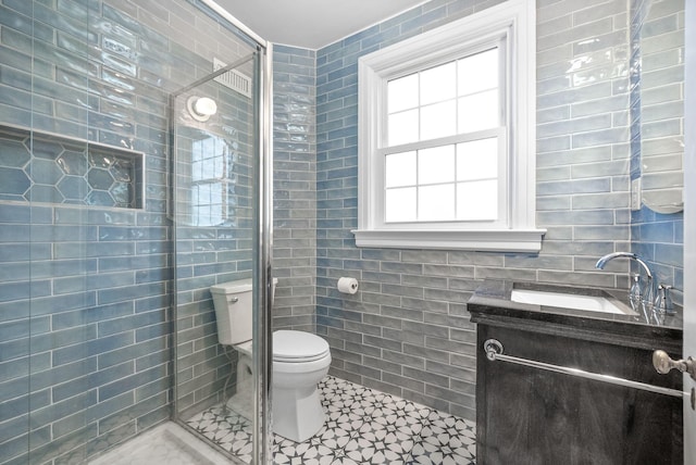 bathroom with plenty of natural light, toilet, tile walls, and walk in shower