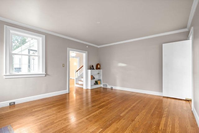 unfurnished living room featuring light wood-type flooring and ornamental molding