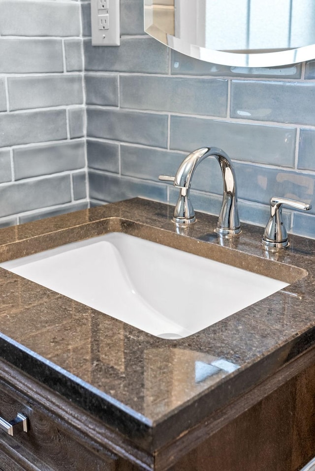 room details featuring decorative backsplash and sink