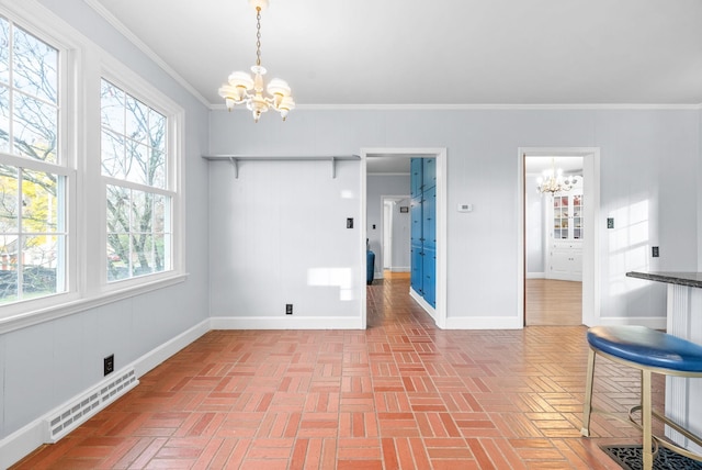 unfurnished dining area with crown molding and a chandelier