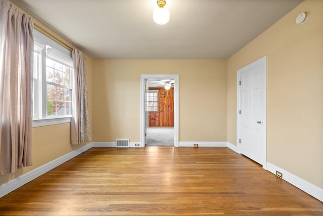 empty room with light hardwood / wood-style flooring