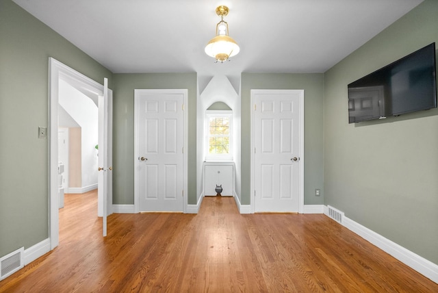 unfurnished bedroom with wood-type flooring