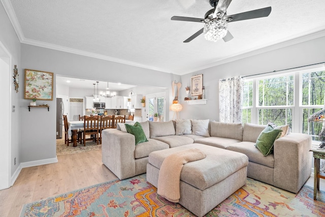 living room with a textured ceiling, ceiling fan, light wood-type flooring, and ornamental molding