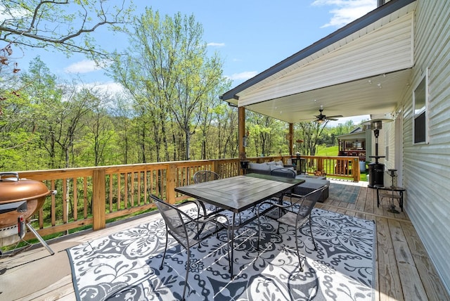 deck with grilling area and ceiling fan