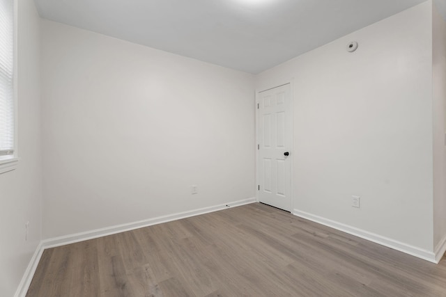 empty room with hardwood / wood-style floors