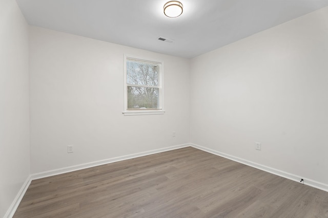 unfurnished room featuring hardwood / wood-style floors