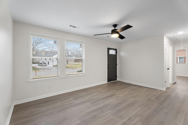 empty room featuring ceiling fan and light hardwood / wood-style flooring