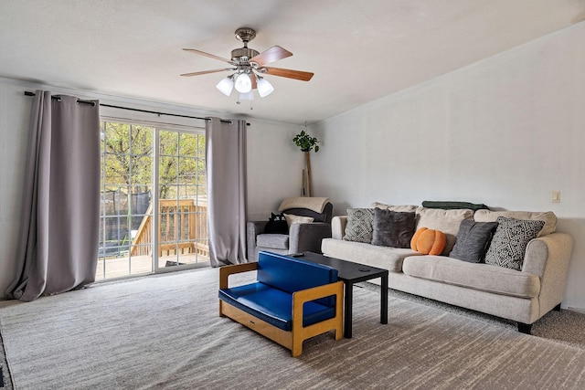 living area with a ceiling fan and carpet