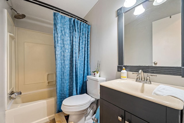 bathroom with a textured ceiling, vanity, toilet, and shower / bath combo with shower curtain