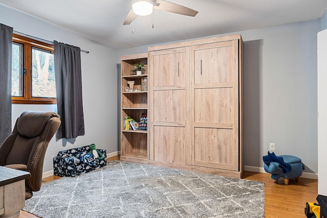 office area featuring ceiling fan, wood finished floors, and baseboards