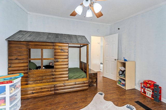 bedroom with ceiling fan, crown molding, baseboards, and wood finished floors