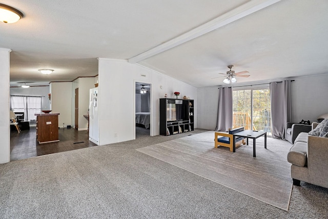 carpeted living room with vaulted ceiling with beams and ceiling fan