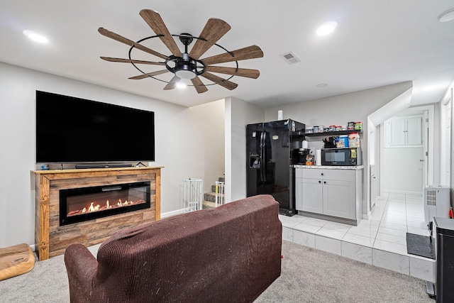 living room with recessed lighting, visible vents, ceiling fan, and a glass covered fireplace