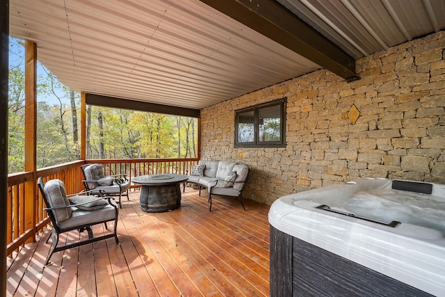 wooden deck featuring an outdoor living space with a fire pit and a hot tub