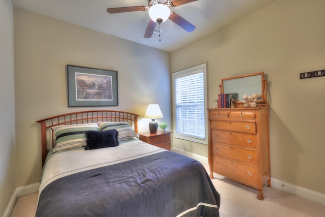 bedroom with ceiling fan and light carpet