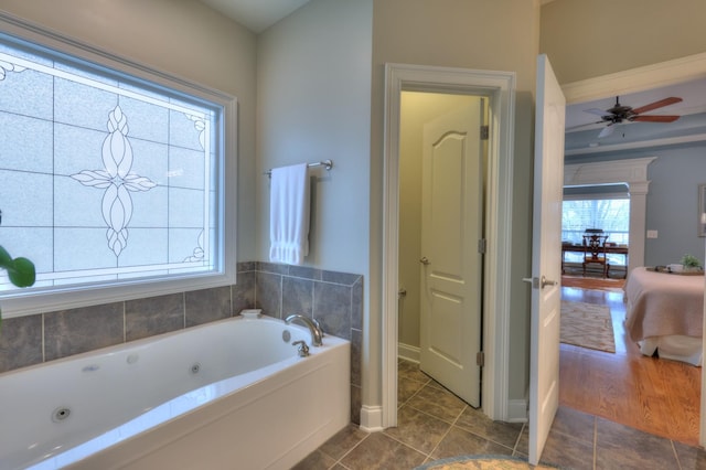 bathroom featuring ceiling fan, tile patterned flooring, and a bathtub