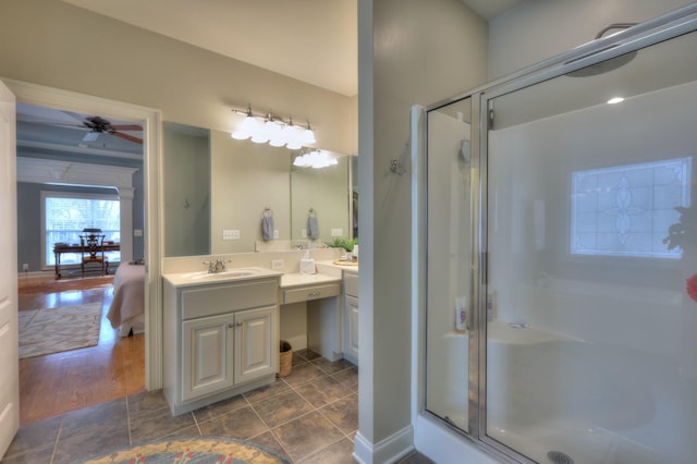 bathroom with tile patterned flooring, vanity, ceiling fan, and a shower with shower door