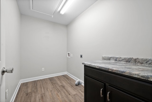 washroom featuring electric dryer hookup, cabinets, washer hookup, and light hardwood / wood-style floors