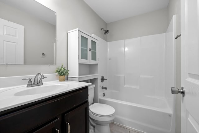 full bathroom with tile patterned floors, vanity, tub / shower combination, and toilet