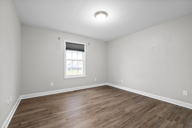 spare room featuring dark hardwood / wood-style flooring