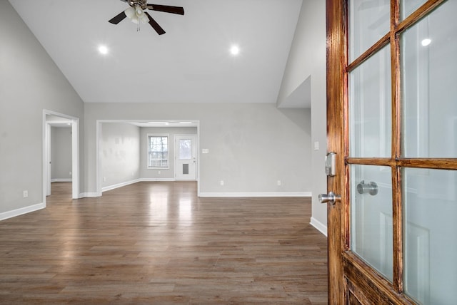 unfurnished living room with dark hardwood / wood-style flooring, ceiling fan, and lofted ceiling