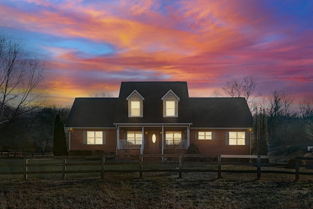 new england style home featuring a porch