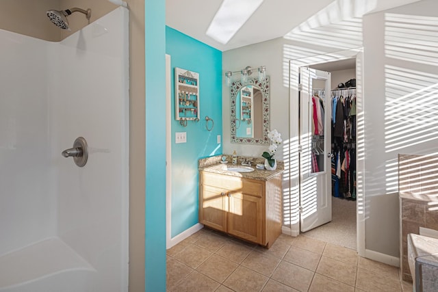 bathroom with vanity, tile patterned floors, and a shower