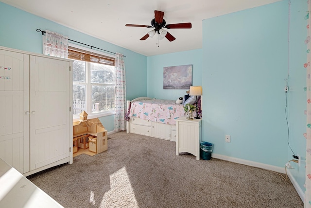 bedroom featuring ceiling fan and carpet