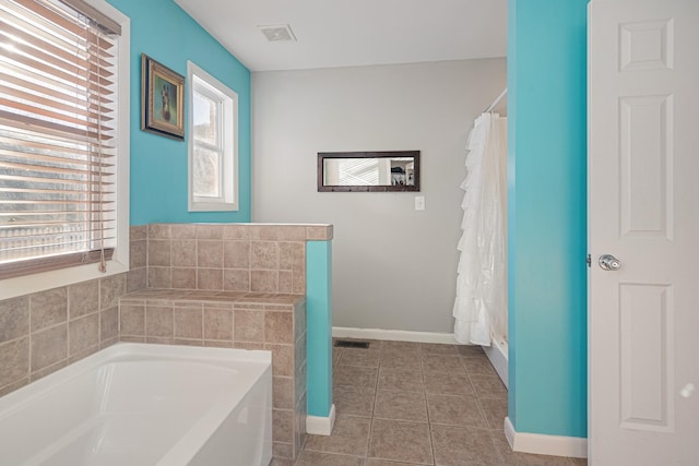 bathroom featuring tile patterned floors and a tub