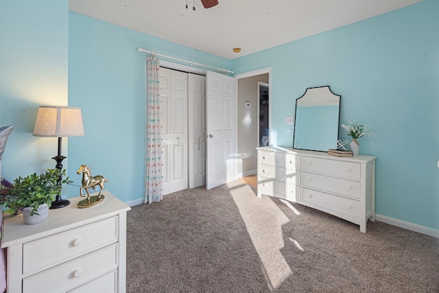 bedroom with light colored carpet, ceiling fan, and a closet