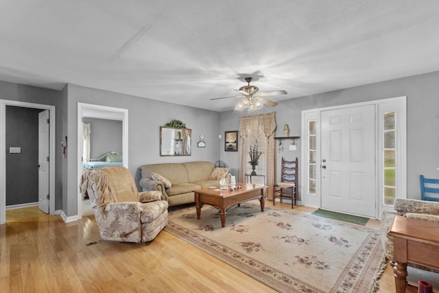 living room featuring hardwood / wood-style floors and ceiling fan