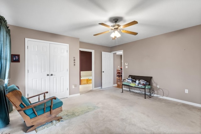 sitting room with ceiling fan and light colored carpet