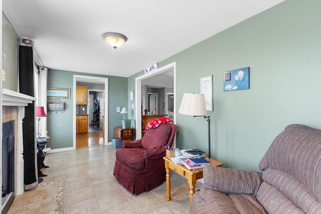 sitting room with a fireplace and light tile patterned floors